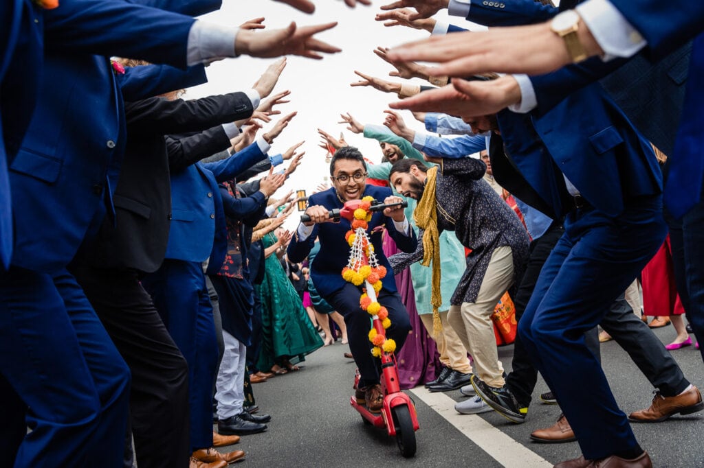 Groom scooting through the guests during his Baraat at a Phoenix Arizona Wedding Ceremony
